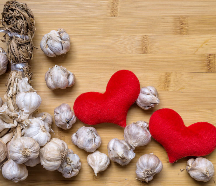 garlic bulbs next to felted hearts