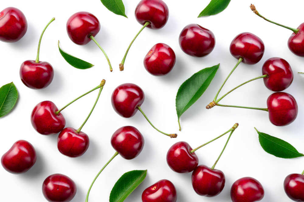 cherries laid out on white background
