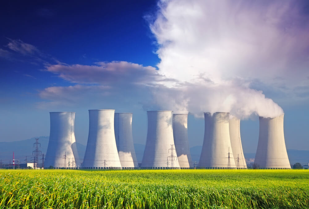 Nuclear power plant with yellow field and big blue clouds