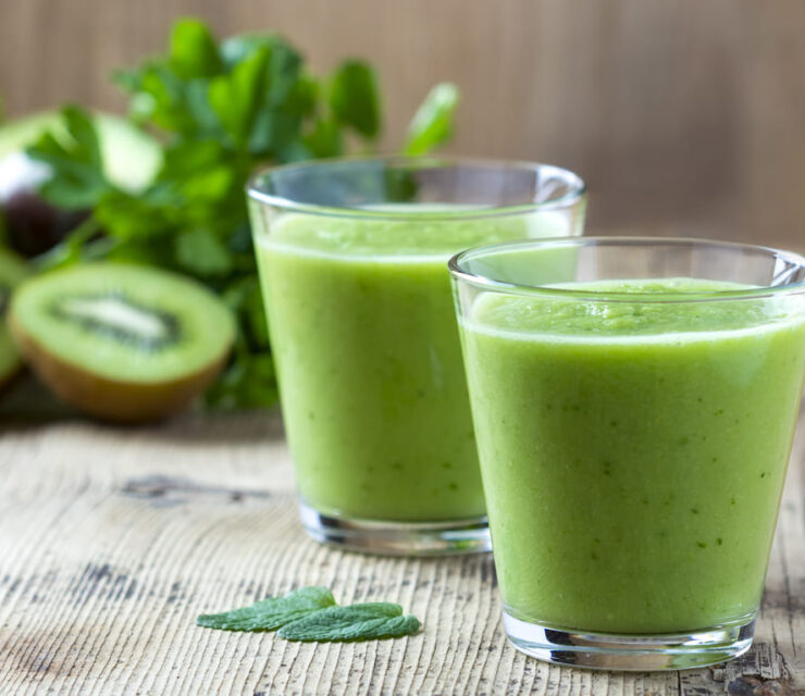 Healthy green Smoothie on wooden table