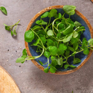 Raw Green Organic Watercress in a Bow, top view.