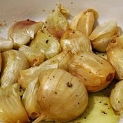 52 cloves of roasted garlic in a white bowl
