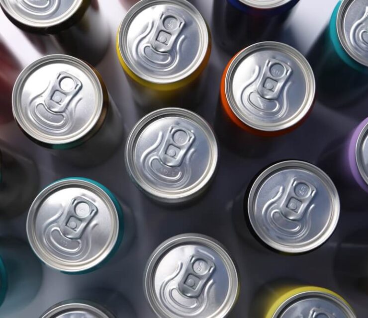 Many aluminium cans of beverage on table, flat lay