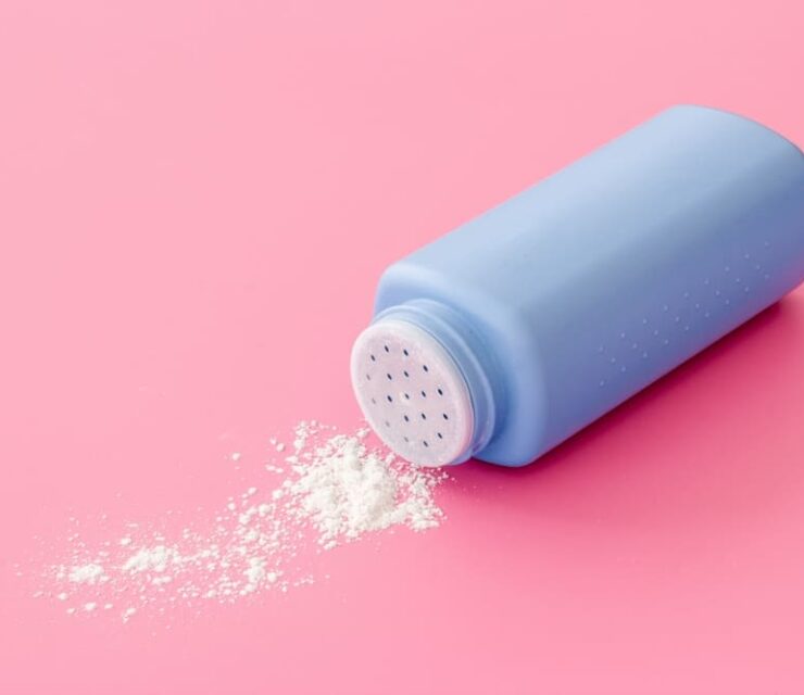Talcum powder in container. Spilled white powder