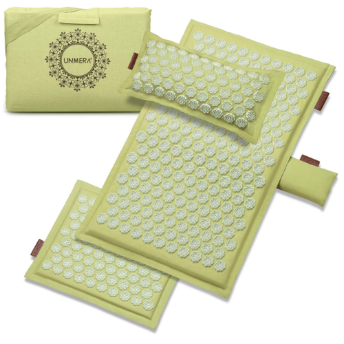 green acupressure mat and pillow on white background