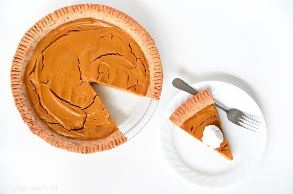 birds-eye view of pumpkin pie with slice taken out