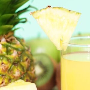 Pineapple Juice and fruit on light background